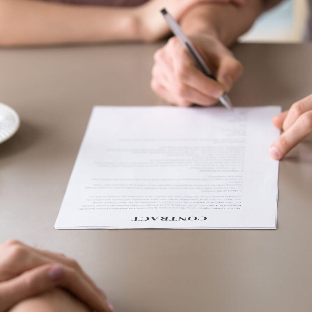 Man signing loan contract for family needs, health insurance for young families, couple agreed to take mortgage to buy apartment flat, close up of male hand putting signature on document